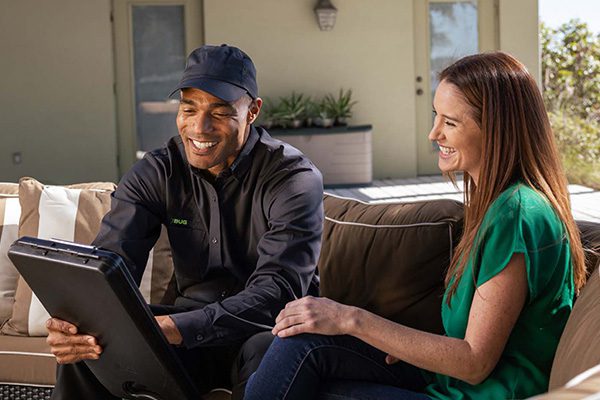 A Bug Out FL technician talking to a customer.