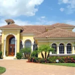Bright yellow house protected by Bug Out home services that offer long-term pest control