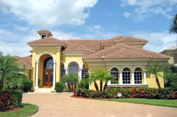 Bright yellow house protected by Bug Out home services that offer long-term pest control