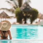 Woman enjoying a mosquito free vacation at her hotel pool.