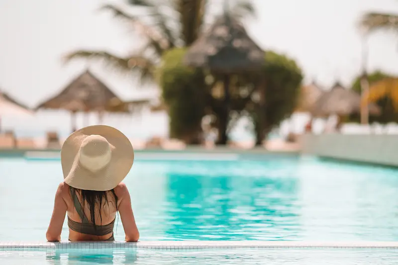 Woman enjoying a mosquito free vacation at her hotel pool.