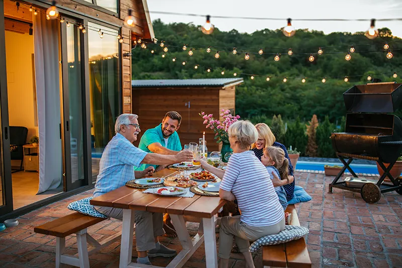 Family on their backyard patio at evening