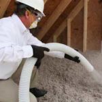 Man installing TAP insulation in a Florida attic