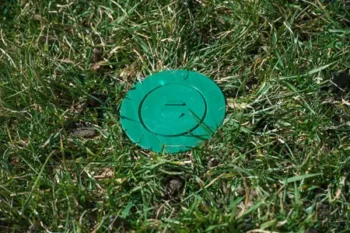 A termite bait station in the ground of a Missouri yard